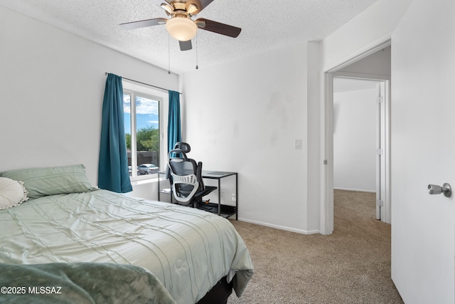 bedroom with carpet floors, a textured ceiling, baseboards, and ceiling fan