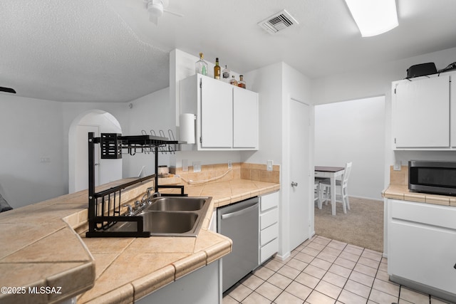 kitchen with visible vents, ceiling fan, light colored carpet, white cabinets, and appliances with stainless steel finishes