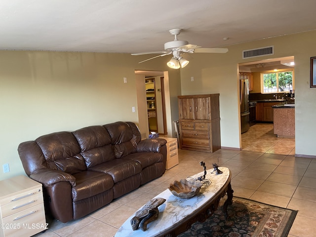 living room featuring visible vents, a ceiling fan, and light tile patterned floors