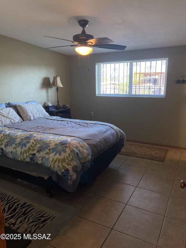 bedroom with tile patterned floors and a ceiling fan