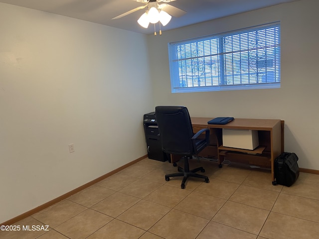office space with baseboards, a ceiling fan, and light tile patterned floors