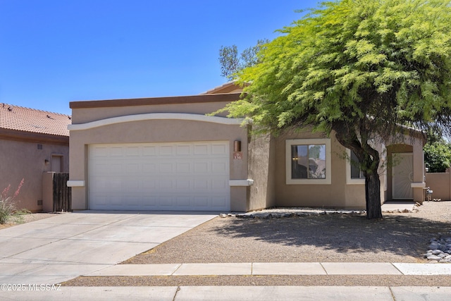 view of front of home featuring a garage, stucco siding, driveway, and a tiled roof