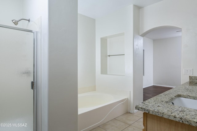 full bathroom featuring vanity, tile patterned flooring, a shower stall, and a bath