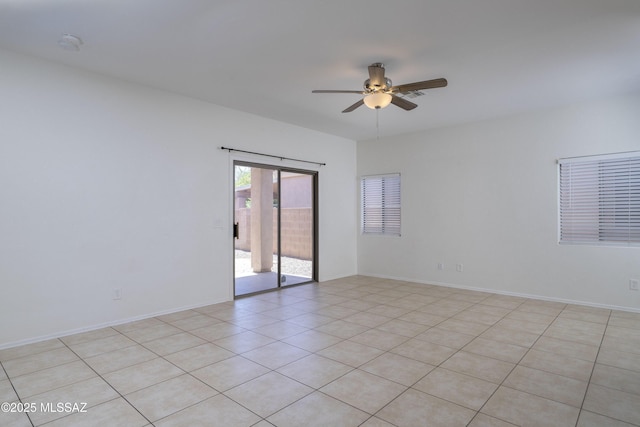 empty room featuring a ceiling fan and light tile patterned floors