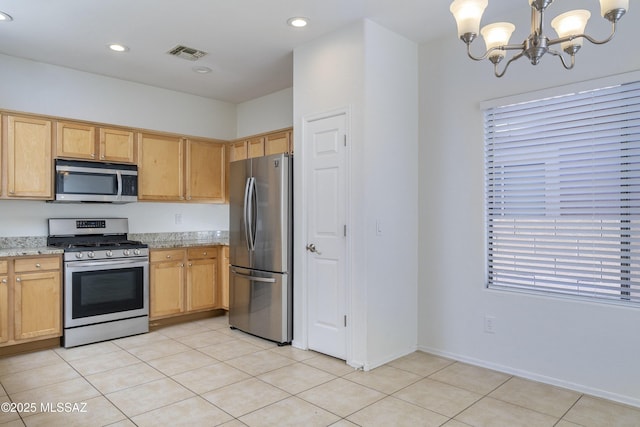 kitchen with visible vents, light tile patterned flooring, a chandelier, light stone counters, and appliances with stainless steel finishes