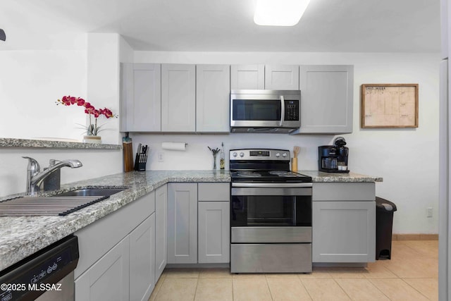 5675 N Camino Esplendora Unit 1103, Tucson, AZ 85718 - kitchen featuring stainless steel appliances, a sink, gray cabinets, light tile patterned floors, and light stone countertops