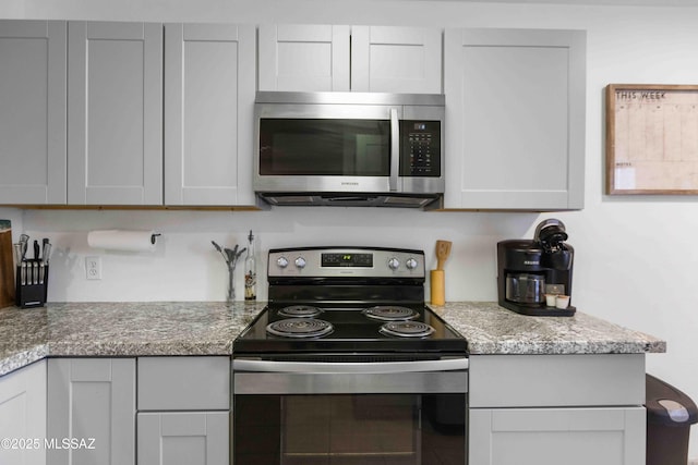 5675 N Camino Esplendora Unit 1103, Tucson, AZ 85718 - kitchen with appliances with stainless steel finishes and light stone countertops