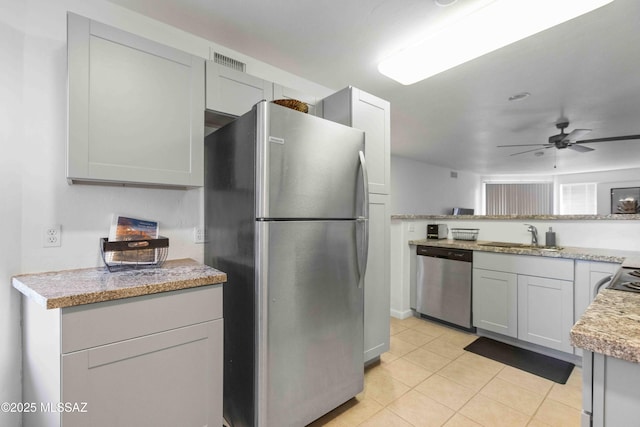 5675 N Camino Esplendora Unit 1103, Tucson, AZ 85718 - kitchen featuring appliances with stainless steel finishes, a sink, light tile patterned floors, and ceiling fan