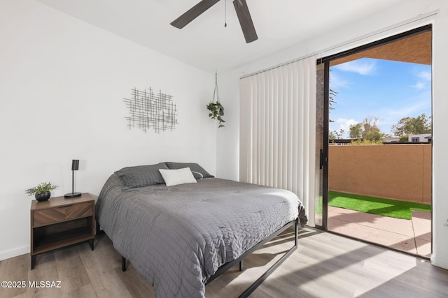 5675 N Camino Esplendora Unit 1103, Tucson, AZ 85718 - bedroom with wood finished floors, access to exterior, and ceiling fan