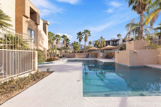 5675 N Camino Esplendora Unit 1103, Tucson, AZ 85718 - community pool with a patio and fence