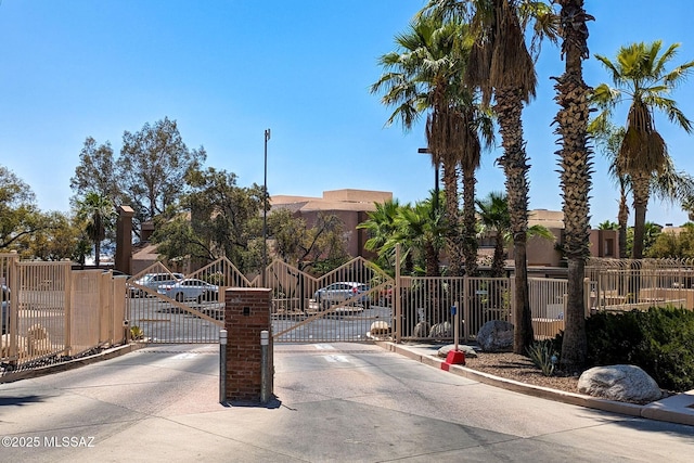 5675 N Camino Esplendora Unit 1103, Tucson, AZ 85718 - view of concrete street featuring curbs, a gate, a gated entry, and a residential view