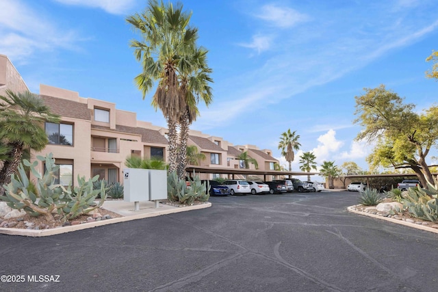 5675 N Camino Esplendora Unit 1103, Tucson, AZ 85718 - view of property with covered parking and a residential view