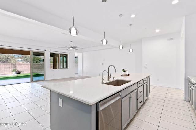 kitchen with light tile patterned flooring, a sink, light countertops, stainless steel dishwasher, and gray cabinetry