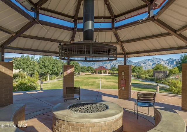 view of patio with a mountain view, a gazebo, and an outdoor fire pit