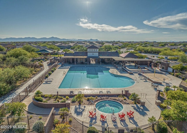 pool with fence and a community hot tub
