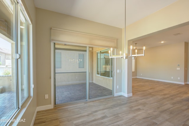 62908 E Thunder Rock Dr, Tucson, AZ 85739 - interior space with baseboards, an inviting chandelier, and wood finished floors