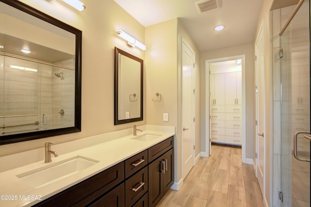62908 E Thunder Rock Dr, Tucson, AZ 85739 - full bath with a sink, double vanity, a shower stall, and visible vents