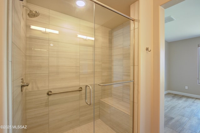 62908 E Thunder Rock Dr, Tucson, AZ 85739 - bathroom featuring visible vents, baseboards, and a stall shower