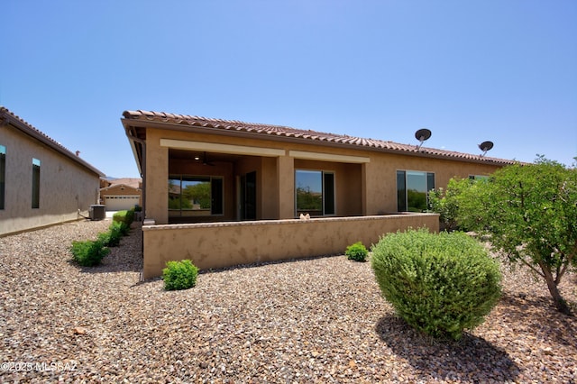 62908 E Thunder Rock Dr, Tucson, AZ 85739 - back of house with central AC unit, stucco siding, a tiled roof, and fence