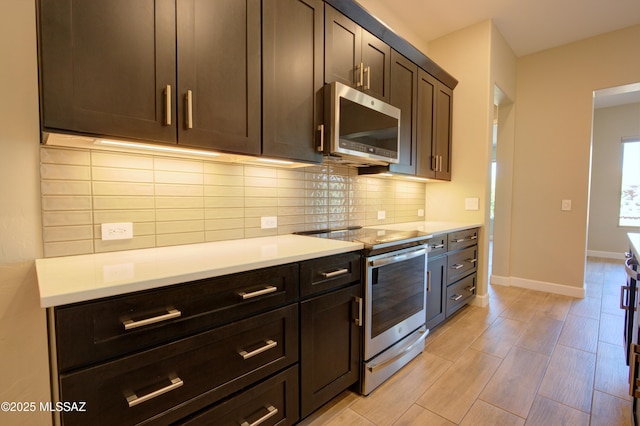 62908 E Thunder Rock Dr, Tucson, AZ 85739 - kitchen with baseboards, light countertops, appliances with stainless steel finishes, and decorative backsplash