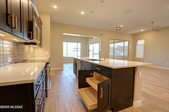 62908 E Thunder Rock Dr, Tucson, AZ 85739 - kitchen with a sink, backsplash, baseboards, and plenty of natural light