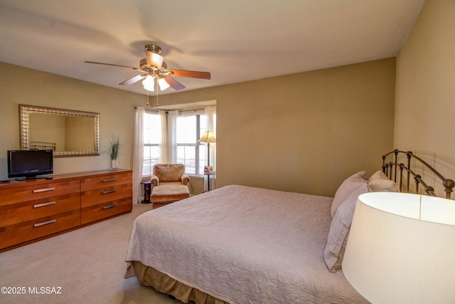 bedroom with light colored carpet and a ceiling fan