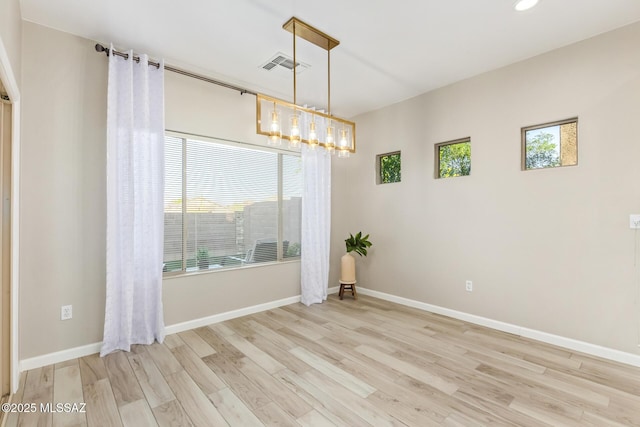 spare room with baseboards, recessed lighting, wood finished floors, and visible vents