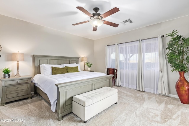bedroom with a ceiling fan, visible vents, and light carpet
