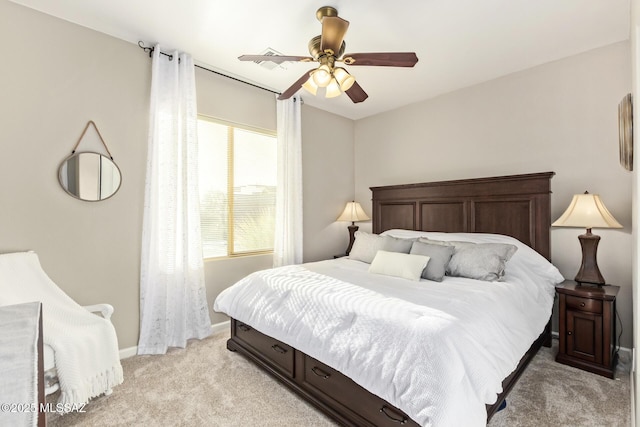 bedroom featuring light colored carpet, baseboards, and ceiling fan