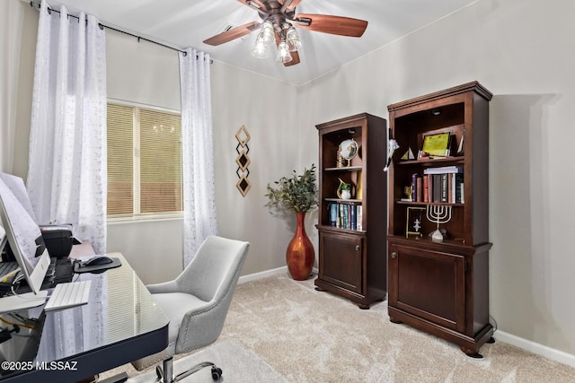 office area with ceiling fan, light carpet, and baseboards