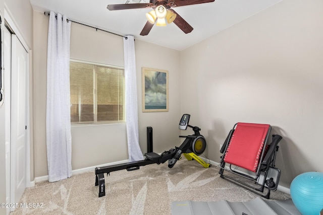 workout area featuring carpet floors, a ceiling fan, and baseboards