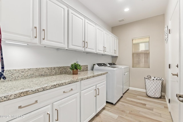 laundry room with independent washer and dryer, cabinet space, light wood-style flooring, recessed lighting, and visible vents