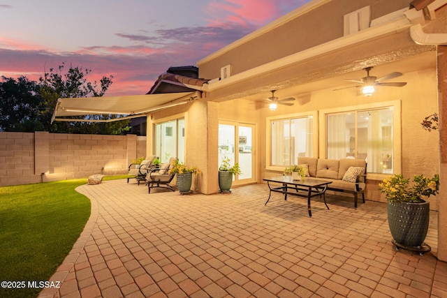 view of patio featuring ceiling fan, outdoor lounge area, and fence