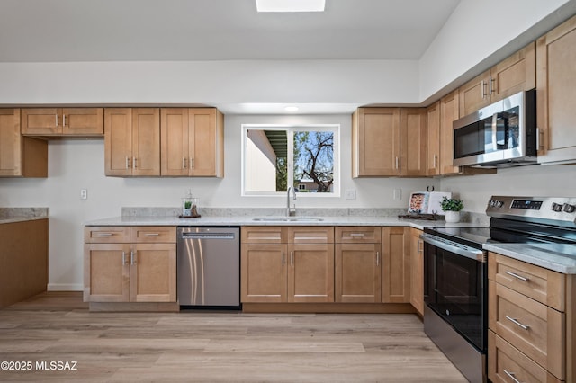 9453 E Pena Dr, Tucson, AZ 85730 - kitchen featuring baseboards, light stone counters, a sink, light wood finished floors, and appliances with stainless steel finishes
