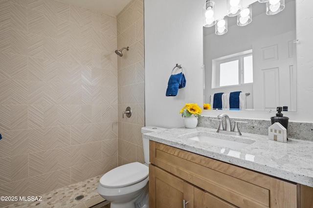 9453 E Pena Dr, Tucson, AZ 85730 - bathroom with toilet, a tile shower, and vanity