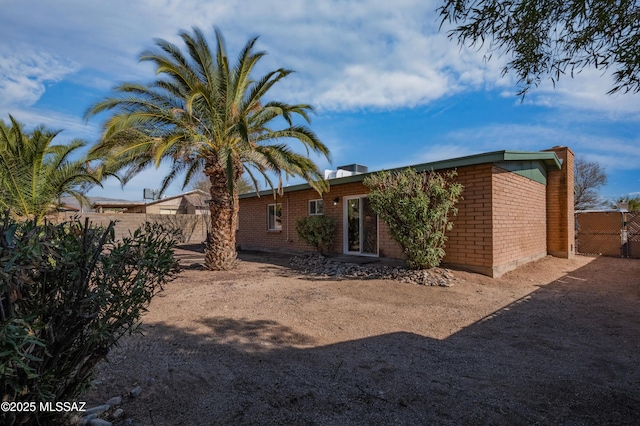 9453 E Pena Dr, Tucson, AZ 85730 - rear view of property featuring brick siding and fence