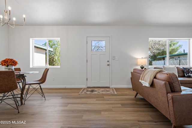 9453 E Pena Dr, Tucson, AZ 85730 - entryway featuring an inviting chandelier, plenty of natural light, and light wood-style floors
