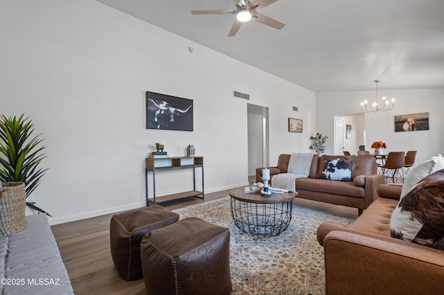 9453 E Pena Dr, Tucson, AZ 85730 - living room featuring baseboards, ceiling fan with notable chandelier, wood finished floors, and visible vents