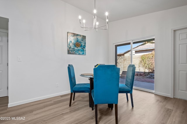 9453 E Pena Dr, Tucson, AZ 85730 - dining area featuring baseboards, wood finished floors, and a notable chandelier
