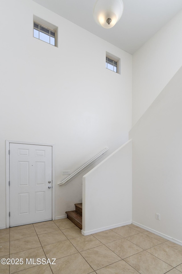 stairway featuring tile patterned floors and baseboards