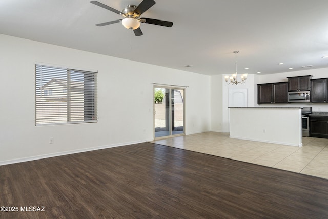 unfurnished living room with a chandelier, light wood finished floors, ceiling fan, recessed lighting, and baseboards