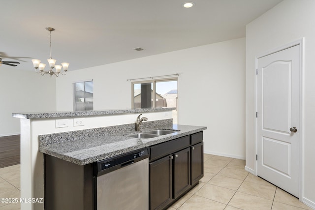 kitchen featuring stainless steel dishwasher, a sink, pendant lighting, a kitchen island with sink, and light tile patterned flooring