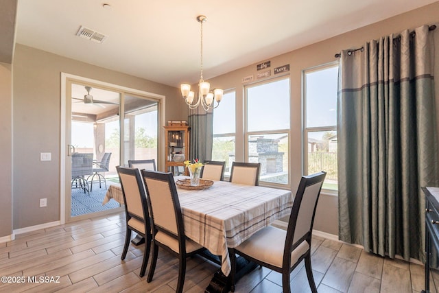 dining area with baseboards, an inviting chandelier, light wood-type flooring, and visible vents