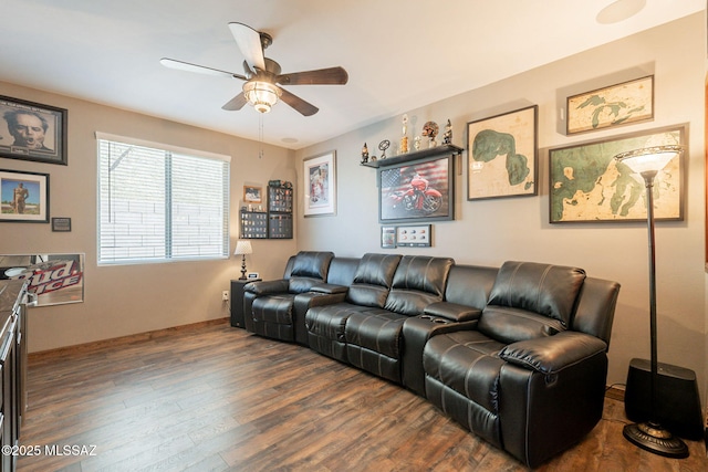 living area featuring dark wood-style flooring and a ceiling fan