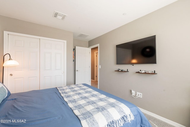 bedroom featuring carpet floors, baseboards, visible vents, and a closet