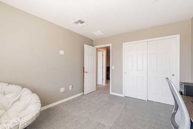 bedroom with a closet, visible vents, baseboards, and light carpet