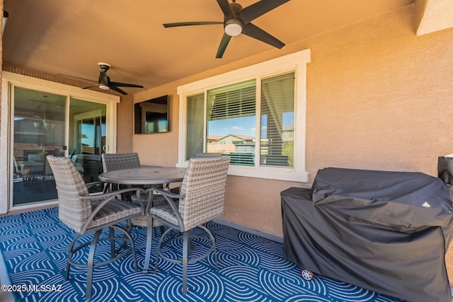 view of patio featuring outdoor dining area and ceiling fan