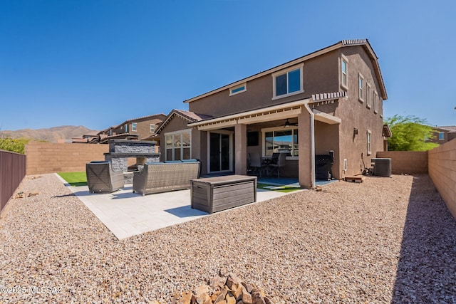 back of house featuring a patio, stucco siding, central AC unit, and a fenced backyard