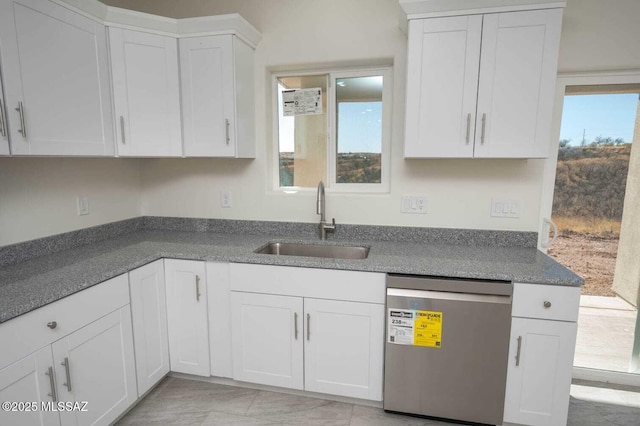 kitchen with a sink, white cabinets, and dishwasher