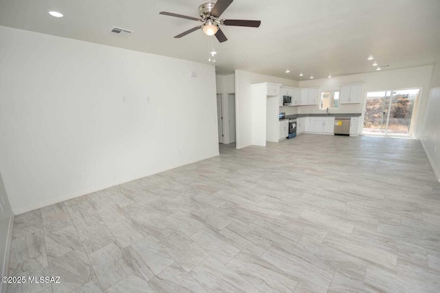 unfurnished living room featuring recessed lighting, ceiling fan, visible vents, and a sink